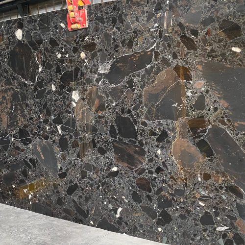 High-quality Black Beauty Marble slab displaying a deep black background with striking white and golden veins and volcanic accents.