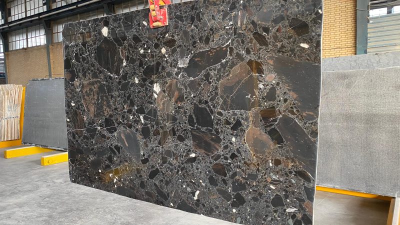 High-quality Black Beauty Marble slab displaying a deep black background with striking white and golden veins and volcanic accents.