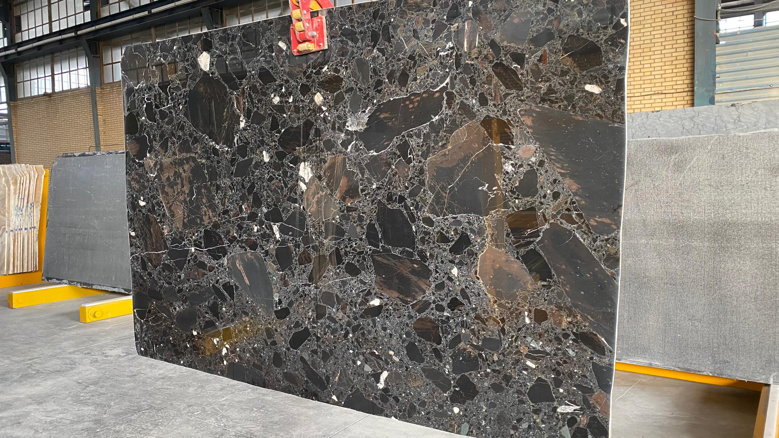 High-quality Black Beauty Marble slab displaying a deep black background with striking white and golden veins and volcanic accents.