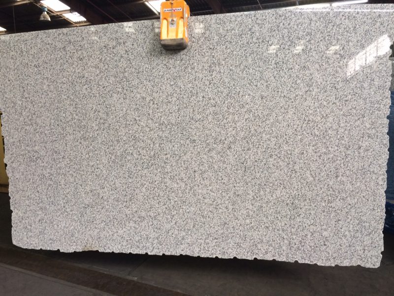 Close-up of Grey Sardo granite showing a uniform grey, black, and white speckled granular pattern.