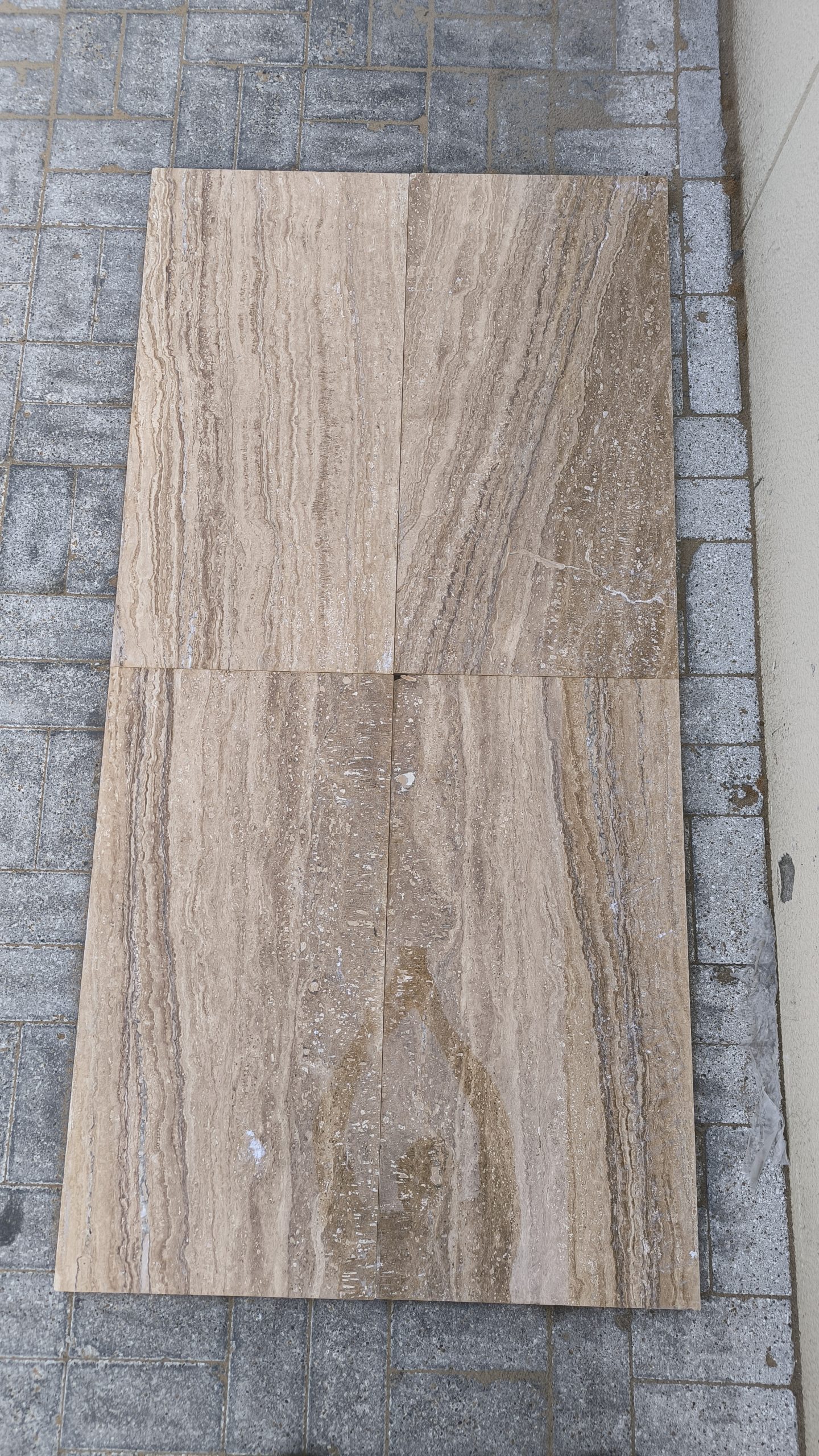 Close-up of Travertine Notcha Light NR showing natural unfilled pores and soft warm walnut and beige tones.