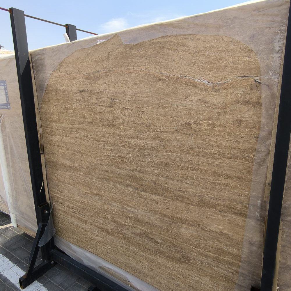 High-quality Travertine Notcha Kachan Dark slab showing intense chocolate brown and deep walnut tones with a natural porous texture.