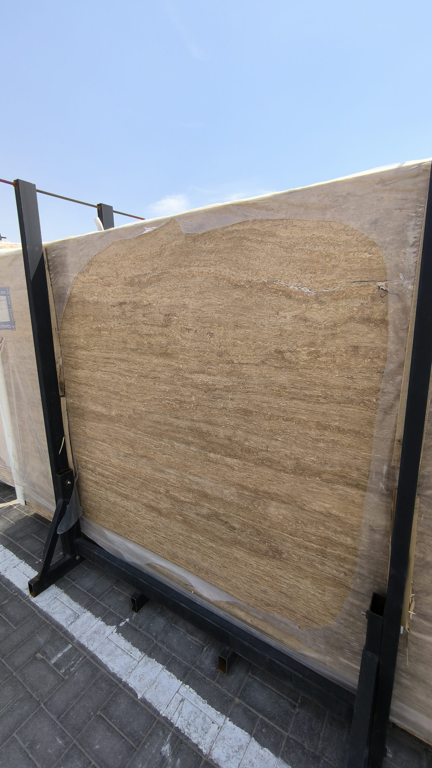 High-quality Travertine Notcha Kachan Dark slab showing intense chocolate brown and deep walnut tones with a natural porous texture.