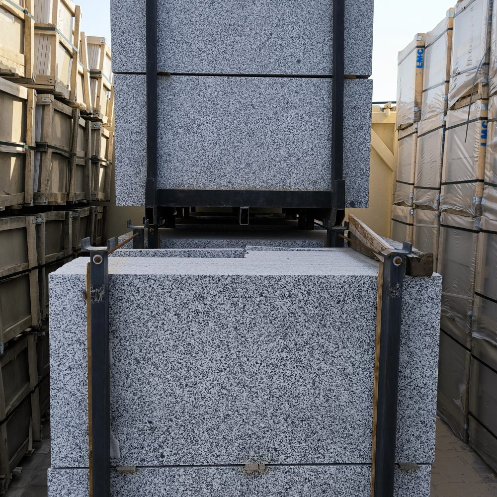 Close-up of Grey Sardo granite showing a uniform grey, black, and white speckled granular pattern.