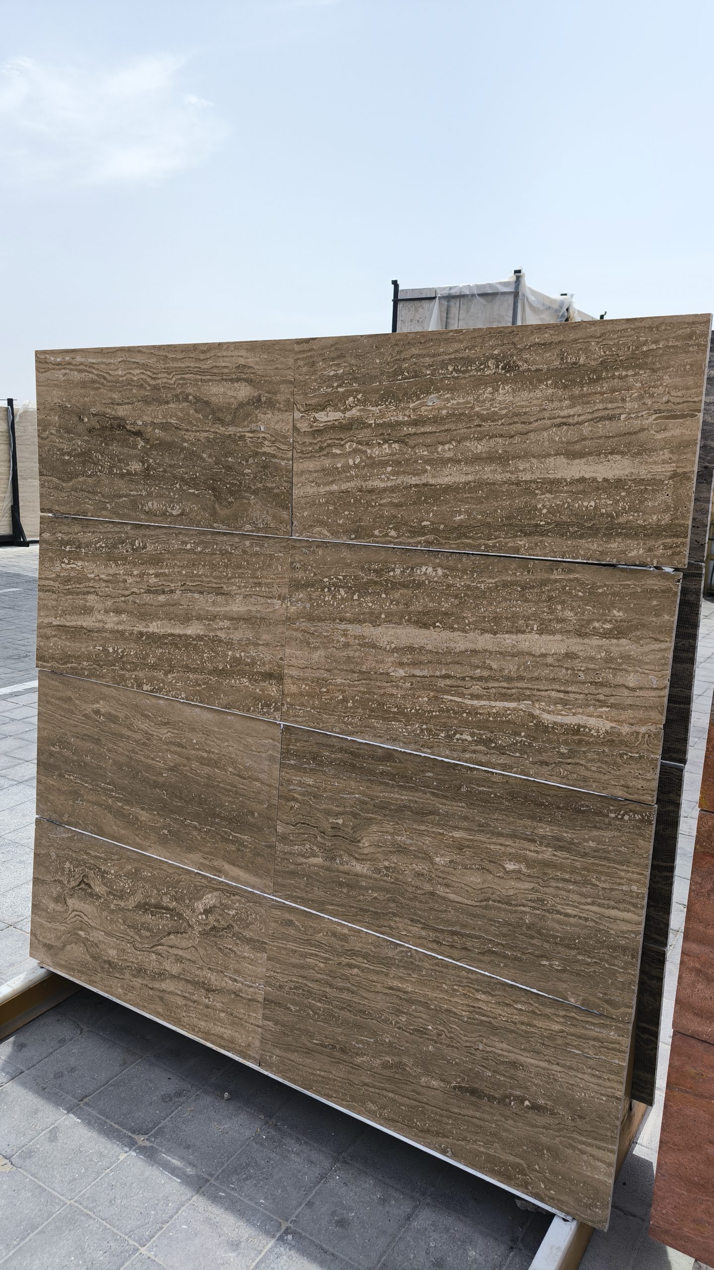 High-quality Travertine Notcha slab displaying rich dark walnut, deep beige, and subtle chocolate tones with a natural porous texture.