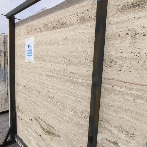 High-quality Travertine Sarlak slab displaying a luminous creamy beige background with soft linear veining.