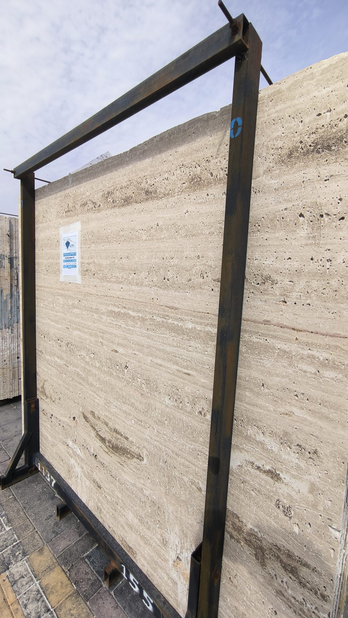 High-quality Travertine Sarlak slab displaying a luminous creamy beige background with soft linear veining.