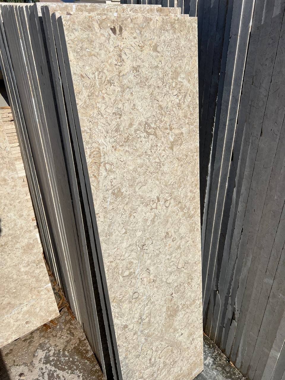 High-quality Imperial Marble slab displaying a warm cream background intersected by dynamic, chaotic veining in beige and brown tones.