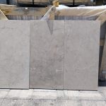 High-quality Creama Marfil Shine Marble slab displaying an ultra-polished, highly reflective bright cream and ivory background.