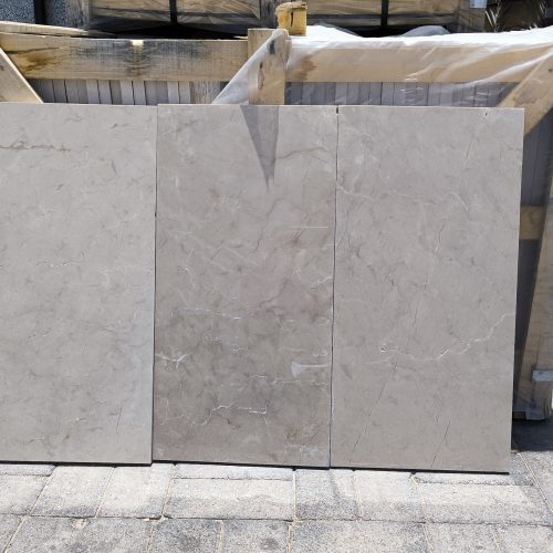 High-quality Creama Marfil Shine Marble slab displaying an ultra-polished, highly reflective bright cream and ivory background.